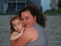 Margaret holding Isabel on the beach, June 2008